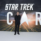 Stewart in front of a large picard logo.
